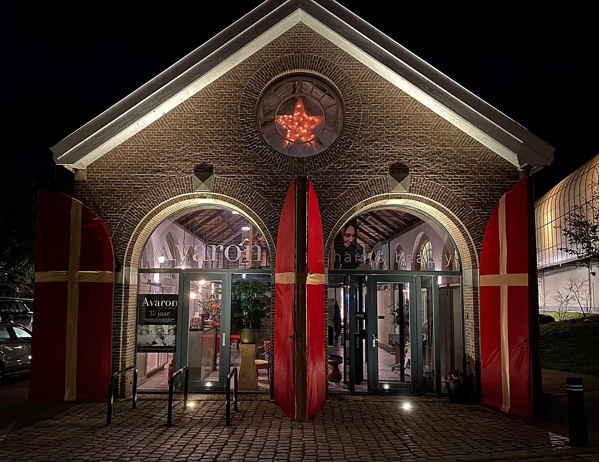 De gevel van de Affuitloods in de avond, met de twee boogdeuren en het ronde venster